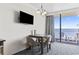 Bright dining area with ocean view, featuring a modern table and chairs with access to a sunny balcony at 1105 S Ocean Blvd. # 904, Myrtle Beach, SC 29577