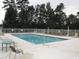 Community pool surrounded by lounge chairs and a fenced perimeter at 1131 White Tree Ln. # 31-J, Myrtle Beach, SC 29588