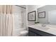 Clean bathroom featuring a shower-tub combo, a dark vanity and a framed art print at 116 Fair Meadow Ct., Loris, SC 29569