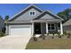 Charming single-Gathering home featuring a welcoming front porch and a two-car garage with beautiful lawn at 116 Fair Meadow Ct., Loris, SC 29569