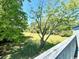 View of backyard with green grass and large trees at 10301 N Kings Highway # 15-8, Myrtle Beach, SC 29572