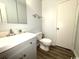 Simple bathroom with gray vanity and wood-look vinyl flooring at 10301 N Kings Highway # 15-8, Myrtle Beach, SC 29572