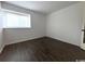 Simple bedroom with dark brown wood-look vinyl flooring and a window at 10301 N Kings Highway # 15-8, Myrtle Beach, SC 29572