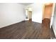 Bright bedroom with dark brown wood-look vinyl flooring and mirrored closet doors at 10301 N Kings Highway # 15-8, Myrtle Beach, SC 29572