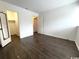 Spacious bedroom with dark brown wood-look vinyl flooring and access to closet and hallway at 10301 N Kings Highway # 15-8, Myrtle Beach, SC 29572