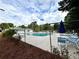 Community pool with lounge chairs and umbrella at 10301 N Kings Highway # 15-8, Myrtle Beach, SC 29572