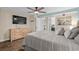 Bright bedroom featuring a king bed, dresser, tv and ensuite bathroom at 6804 N Ocean Blvd. # 1037, Myrtle Beach, SC 29572
