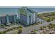 Coastal condo building featuring a unique yellow and white design with ocean views and a parking garage at 6804 N Ocean Blvd. # 1037, Myrtle Beach, SC 29572