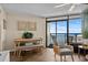 Living room with dining area featuring tile floors, a ceiling fan, and large sliding glass doors with ocean views at 6804 N Ocean Blvd. # 1037, Myrtle Beach, SC 29572