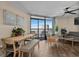 Living room with dining area featuring tile floors, a ceiling fan, and large sliding glass doors with ocean views at 6804 N Ocean Blvd. # 1037, Myrtle Beach, SC 29572