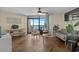 Cozy living room featuring tile floors, a ceiling fan, and large sliding glass doors with ocean views at 6804 N Ocean Blvd. # 1037, Myrtle Beach, SC 29572