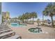 Outdoor swimming pool with brick deck, hot tub, palm trees, lounge chairs and beach access at 6804 N Ocean Blvd. # 1037, Myrtle Beach, SC 29572