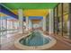 Indoor winding pool area with large windows and a colorful ceiling at 6804 N Ocean Blvd. # 1037, Myrtle Beach, SC 29572