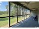 Relaxing screened porch with ceiling fans, providing outdoor living space with views of lush lawn and blue skies at 923 Fairwood Lakes Ln. # 23-Q, Myrtle Beach, SC 29588