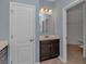 Bathroom with dark vanity, single sink and access to closet at 103 Palmetto Green Dr. # 103, Longs, SC 29568