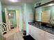 Well-lit bathroom with double sinks, granite countertops, and plenty of storage space at 8500 Margate Circle # 2005, Myrtle Beach, SC 29572