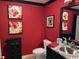 Bathroom features red walls, black trim, stylish vanity, and artistic decor at 8500 Margate Circle # 2005, Myrtle Beach, SC 29572