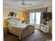 Comfortable bedroom featuring a ceiling fan, view, TV, and coastal decor at 8500 Margate Circle # 2005, Myrtle Beach, SC 29572