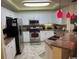 Bright kitchen features white cabinetry, granite countertops, and stainless steel appliances at 8500 Margate Circle # 2005, Myrtle Beach, SC 29572