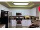 Bright kitchen features white cabinetry, granite countertops, and stainless steel appliances at 8500 Margate Circle # 2005, Myrtle Beach, SC 29572