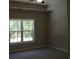 Neutral bedroom features plush carpeting, a large window with outdoor view, and a tray ceiling at Tbd 6 Privetts Rd., Conway, SC 29526