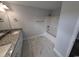 Bright bathroom features a double sink vanity, granite countertops, and a shower-tub combo at Tbd 9 Privetts Rd., Conway, SC 29526