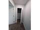 Walk-in closet features an open shelving system, carpet flooring, and a white trimmed doorway at Tbd 9 Privetts Rd., Conway, SC 29526