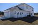 Rear exterior of home shows garage, lawn, white vinyl siding, black roof, and yard at Tbd 9 Privetts Rd., Conway, SC 29526