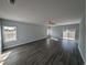 Bright, open living room with wood flooring, fan, and sliding glass door to the backyard at Tbd 9 Privetts Rd., Conway, SC 29526