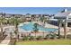 Community pool surrounded by lush landscaping, lounge chairs, palm trees and well-maintained homes at 8080 Laurel Ash Ave., Myrtle Beach, SC 29572