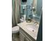 Well-lit bathroom featuring a marble countertop sink, modern fixtures, and soothing teal walls at 9621 Shore Dr. # J-229, Myrtle Beach, SC 29572