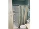 Cozy bathroom featuring a shower with a striped curtain and built-in storage cabinet at 9621 Shore Dr. # J-229, Myrtle Beach, SC 29572