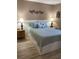 Comfortable bedroom featuring a queen bed, lamps on nightstands and decor over the headboard at 9621 Shore Dr. # J-229, Myrtle Beach, SC 29572