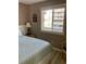 Bedroom with natural light streaming through the window, side tables, and serene decor at 9621 Shore Dr. # J-229, Myrtle Beach, SC 29572
