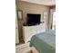 Cozy bedroom featuring a TV atop a white dresser and a comfortable bed with coastal themed bedding at 9621 Shore Dr. # J-229, Myrtle Beach, SC 29572
