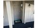 Condo 229 features a welcoming gray front door with beach themed door mat and decorative lights at 9621 Shore Dr. # J-229, Myrtle Beach, SC 29572
