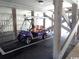 Purple Golf Cart parked under a covered parking area with wood beams at 9621 Shore Dr. # J-229, Myrtle Beach, SC 29572