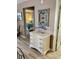 Interior view shows dresser with decor and view into a bedroom with soft blue bedding at 9621 Shore Dr. # J-229, Myrtle Beach, SC 29572