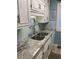 Kitchen featuring stainless steel double sink, faucet, backsplash, stone counters and cabinets at 9621 Shore Dr. # J-229, Myrtle Beach, SC 29572