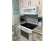 Kitchen showcasing range, microwave, cabinets, tile backsplash and countertops at 9621 Shore Dr. # J-229, Myrtle Beach, SC 29572