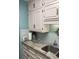 Kitchen featuring stylish cabinets, backsplash, stone counters, stainless sink, and updated fixtures at 9621 Shore Dr. # J-229, Myrtle Beach, SC 29572