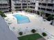 Elevated shot of a complex pool area with lounge chairs and lush palm trees, surrounded by condo buildings at 9621 Shore Dr. # J-229, Myrtle Beach, SC 29572