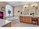 Bright bathroom featuring a soaking tub, double vanities, and a large arched window at 816 Waterton Ave., Myrtle Beach, SC 29579