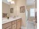 Bright bathroom with double sinks, modern vanity, framed mirror, and tiled floors at 816 Waterton Ave., Myrtle Beach, SC 29579