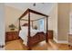 This bedroom features a stunning wood canopy bed, hardwood floors and neutral walls at 816 Waterton Ave., Myrtle Beach, SC 29579