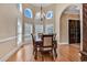 Elegant dining room with hardwood floors, chandelier, and large windows offering ample natural light at 816 Waterton Ave., Myrtle Beach, SC 29579