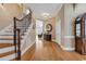 Inviting foyer featuring hardwood floors and a staircase with wrought iron spindles at 816 Waterton Ave., Myrtle Beach, SC 29579