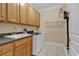 Well-equipped laundry room with ample cabinets, modern washer and dryer, and utility sink at 816 Waterton Ave., Myrtle Beach, SC 29579