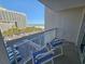 Balcony view of the ocean and a building, with outdoor seating for enjoying the coastal scenery at 9820 Queensway Blvd. # 501, Myrtle Beach, SC 29572