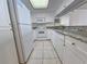Bright kitchen featuring white appliances, granite countertops, and tile flooring providing a clean and modern space at 9820 Queensway Blvd. # 501, Myrtle Beach, SC 29572